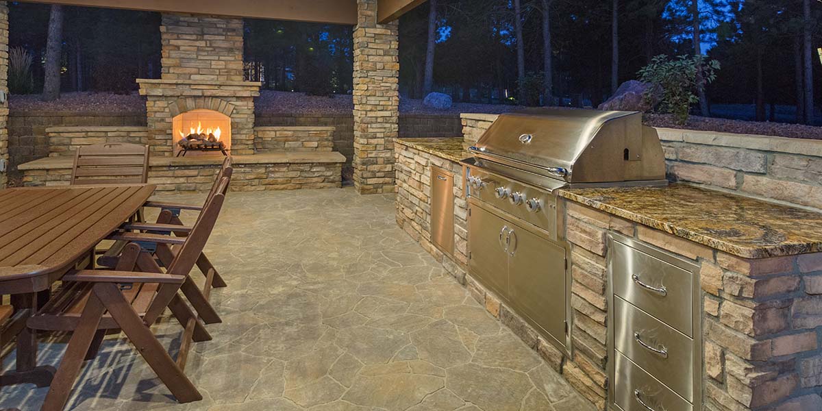 cinderblock outdoor kitchen with brick finish and stone countertop